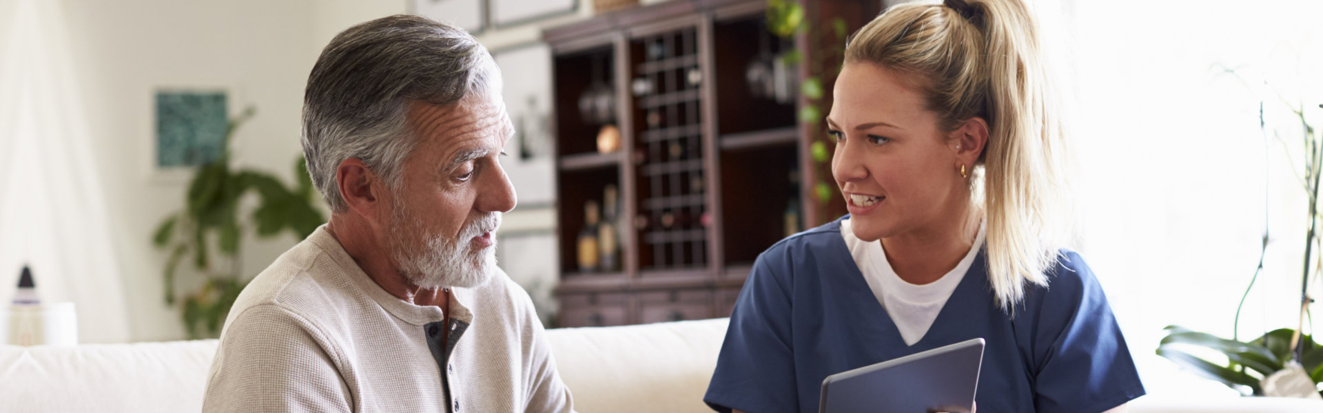 nurse woman talking to a senior patient