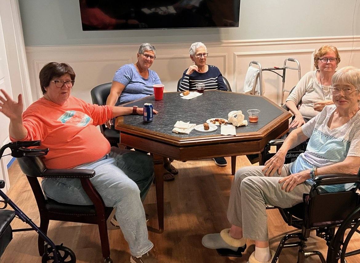 Four people sitting around a card table